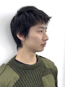 Man with natural, medium-length dark hair before a haircut.