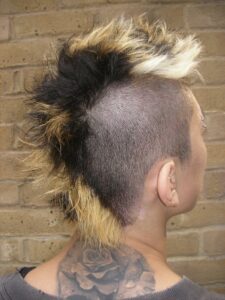 Close-up of tri-tone section colour (black, gold, platinum) on a men's Mohawk.