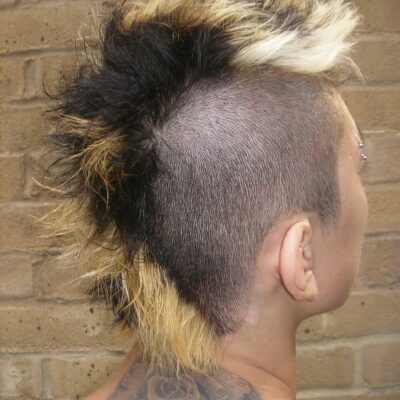 Close-up of tri-tone section colour (black, gold, platinum) on a men's Mohawk.