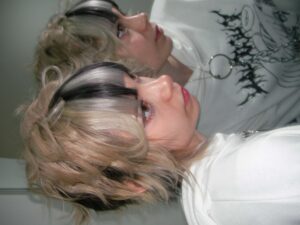 A triple-process creative color with bold fung bangs, inspired by anime aesthetic and protected by K18 treatment.